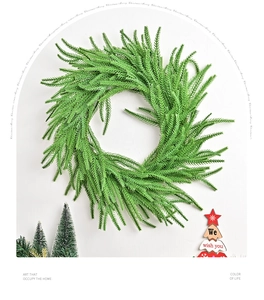 Close-up of artificial Norfolk pine wreath with dense green needles and festive holiday decor