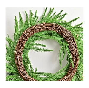 Close-up of Norfolk pine needles on a natural brown rattan base for Christmas decor
