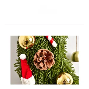 Detailed Christmas moon wreath featuring pine cones, gold baubles, and mini festive hats