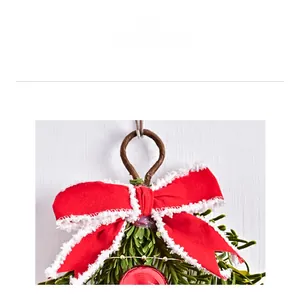Close-up of a Christmas bow ornament with red berries and green pine needles decoration