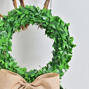 Easter bunny rattan wreath with green leaves and a burlap bow for home garden wall decor