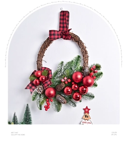 Close-up of Christmas wreath with red berries, pine cones and buffalo plaid bow