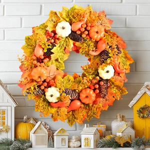 Nordic autumn wreath with pumpkins, maple leaves and berries for Thanksgiving porch decor