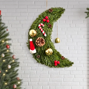 Christmas moon wreath with pine needles, red berries, and candy canes on white wall
