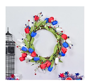 Close-up of red, white and blue tulip wreath with green leaves on rattan base