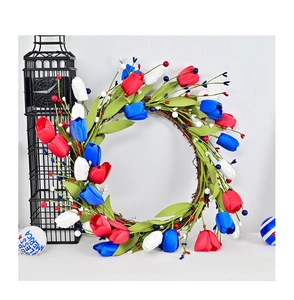 Detail of red white and blue tulip wreath with God Bless America sign on rattan base