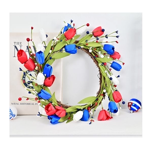 Detailed view of red white and blue tulip wreath with berries on natural vine base