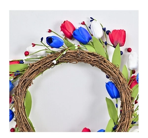 Detailed close-up of red, white, and blue artificial tulips on a natural vine wreath