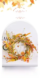 Detailed view of an autumn wreath featuring artificial flowers and berries on a rattan frame