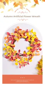 Detail of harvest pumpkin wreath with orange autumn leaves and berries for wall decor