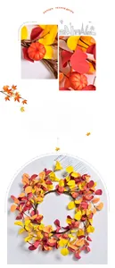 Close-up of autumn wreath featuring faux maple leaves, ginkgo leaves, and mini pumpkins