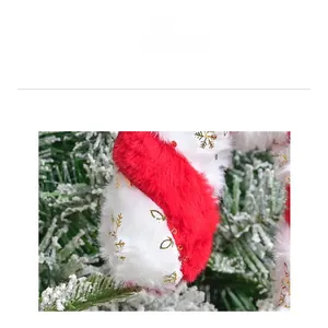 Detailed close-up of plush red and white candy cane ornament with gold snowflake embroidery