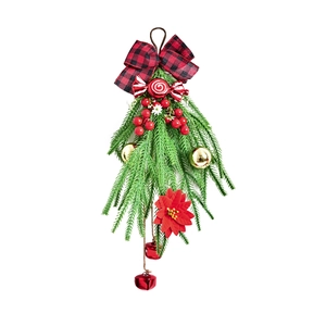 Décoration de Noël suspendue avec branches de pin, nœud rouge, bonbon et baies