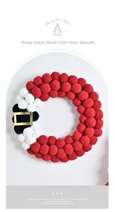 Detail of plush Santa-themed wreath featuring soft red, white and black balls with gold buckle