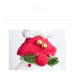 Close-up of plush Christmas tree ornament with faux pine needles and festive red berries