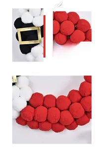 Close-up of Santa plush balls garland with red, white, black pom-poms and gold buckle
