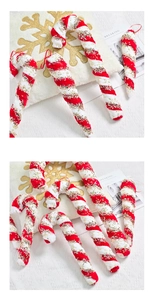 Macro detail of red and white striped Christmas candy cane ornaments with gold glitter