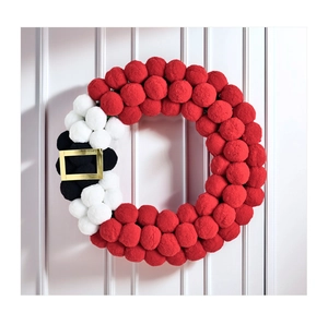 Detail of plush Christmas wreath with red white pom poms and Santa Claus belt buckle
