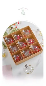 Nine drop-shaped clear PET Christmas ornaments with red snowflakes in a kraft gift box