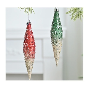 Detail of sequined spindle-shaped Christmas ornaments on a pine tree branch