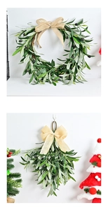 Detailed view of olive branch Christmas wreath and garland with beige burlap bows