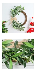 Detail view of artificial olive leaf wreath with natural rattan base and burlap bow tie