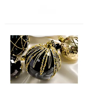 Dettaglio di pallina di Natale nera e oro con glitter e perline fatti a mano
