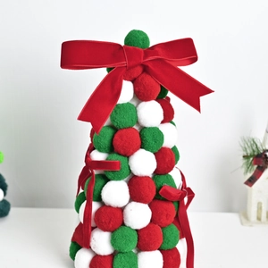 Christmas tree tabletop decor made of red green white felt balls with a velvet bow