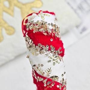 Plush red and white Christmas candy cane ornament with gold sequin trees and snowflakes