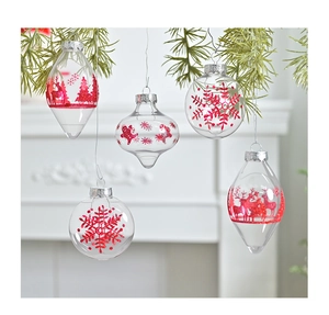 Transparent PET Christmas ornaments with red glitter reindeer patterns hanging on pine branches