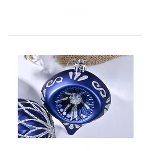 Macro shot of 8cm royal blue Christmas ornaments with silver glitter grid patterns