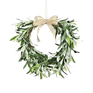 Artificial olive leaf Christmas wreath with a burlap bow and dark berries on white background