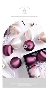 Close-up of luxury satin Christmas ball ornaments in a black gift box on fur