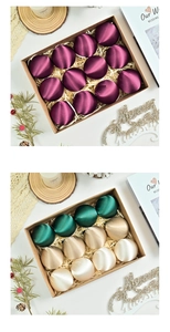 Close-up of assorted velvet satin Christmas balls in premium gift box with raffia
