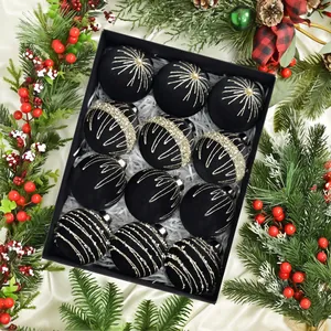 Detail of 12 black velvet Christmas balls with gold glitter patterns in a gift box