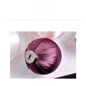 Macro shot of purple satin Christmas ball with elegant pleated texture and silver ring