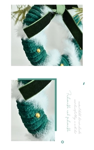Detail of red and green knitted Christmas wreath with velvet bow and golden beads