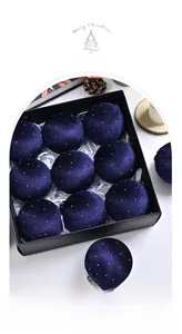 Set of nine navy blue velvet Christmas tree ornaments with white specks in a black gift box