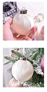 Detail of luxury champagne satin Christmas ornament with pleated texture and silver cap