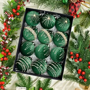 Close-up of 12 dark green velvet Christmas balls with gold and silver glitter in a box