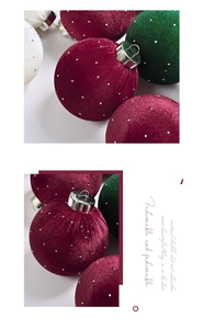 Close-up of velvet Christmas tree ornaments with silver beads in red, green and cream