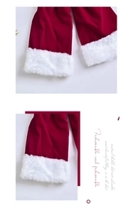 Detailed close-up of red velvet fabric and thick white faux fur trim on Christmas decor