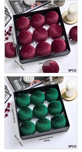 Close-up of velvet Christmas ornaments with white rhinestones in a black gift box