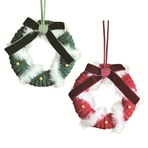 Knitted Christmas wreath hanging ornaments with velvet bow and golden beads on white background
