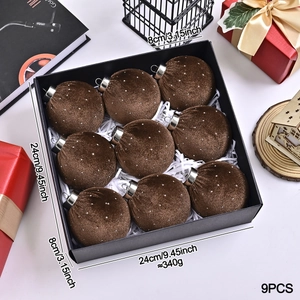 Set of nine brown velvet Christmas ornaments with white specks in a black gift box