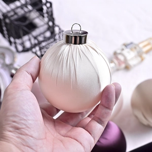 Luxury cream satin Christmas ball ornament with pleated fabric texture and silver cap
