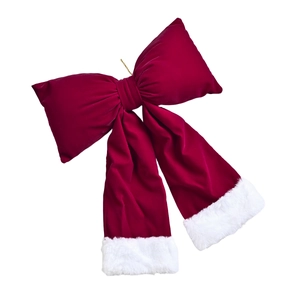 Large red velvet Christmas bow with white plush edges and gold hanging string decor