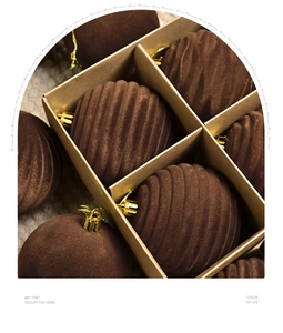 Detailed view of brown flocked Christmas balls with vertical stripes in a kraft gift box