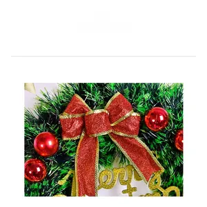 Detail of Christmas wreath with red glitter bow, ornaments and Merry Christmas sign