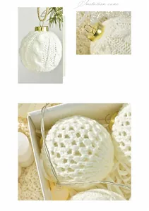 Detail of cream knitted Christmas ball ornament with cable knit texture and gold cap